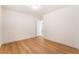 Light-filled bedroom with wood-look flooring and an open doorway at 6821 Treble Clef Ave, Las Vegas, NV 89139
