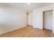 Bright bedroom with hardwood floors, white walls, and closet with sliding doors at 6821 Treble Clef Ave, Las Vegas, NV 89139