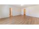 Spacious bedroom with wood-look floors, featuring two doorways and ample natural light at 6821 Treble Clef Ave, Las Vegas, NV 89139