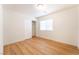 Bedroom featuring wood-look floors, closet with doors, and a window at 6821 Treble Clef Ave, Las Vegas, NV 89139
