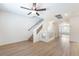 Bright entryway with wood floors, stairs, and a view into another room at 6821 Treble Clef Ave, Las Vegas, NV 89139
