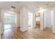 Bright upstairs hallway with wood floors leads to multiple rooms and laundry area at 6821 Treble Clef Ave, Las Vegas, NV 89139