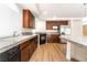 This gorgeous kitchen has wood cabinets, granite countertops, stainless steel appliances, and wood floors at 6821 Treble Clef Ave, Las Vegas, NV 89139