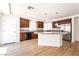 Beautiful kitchen features wood cabinets, stainless steel appliances, and center island with granite countertop at 6821 Treble Clef Ave, Las Vegas, NV 89139