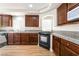Kitchen features wood cabinets, granite countertops, a range oven, and stainless steel refrigerator at 6821 Treble Clef Ave, Las Vegas, NV 89139