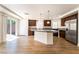 Modern kitchen with granite countertops, stainless steel appliances, and wood floors at 6821 Treble Clef Ave, Las Vegas, NV 89139