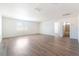 Large living room with hardwood floors, white walls, and view of the window at 6821 Treble Clef Ave, Las Vegas, NV 89139