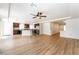Bright open living room with wood floors, recessed lighting, and kitchen view at 6821 Treble Clef Ave, Las Vegas, NV 89139