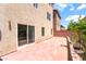 An expansive patio area with a sliding glass door is surrounded by brick wall and lush landscaping at 6821 Treble Clef Ave, Las Vegas, NV 89139