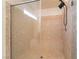Close-up of a newly tiled shower stall with a built-in seat and glass surround at 6821 Treble Clef Ave, Las Vegas, NV 89139
