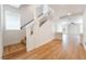 Bright staircase leading to the upper level, featuring wood floors and white walls at 6821 Treble Clef Ave, Las Vegas, NV 89139