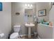 Charming half bathroom with pedestal sink and coastal decor at 6837 Dragonfly Rock St, Las Vegas, NV 89148