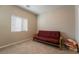 Cozy bedroom with a futon bed, window with blinds, and neutral wall colors at 6837 Dragonfly Rock St, Las Vegas, NV 89148