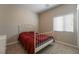 Cozy bedroom with carpeted floors, a white bed frame, and a window for natural light at 6837 Dragonfly Rock St, Las Vegas, NV 89148