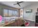 Bright bedroom featuring hardwood floors, a ceiling fan, and a large window for natural light at 6837 Dragonfly Rock St, Las Vegas, NV 89148
