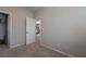 Empty bedroom with carpet and a view into another room, featuring an open closet space at 6837 Dragonfly Rock St, Las Vegas, NV 89148
