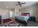 Spacious bedroom with a ceiling fan, hardwood floors, and a stylish area rug at 6837 Dragonfly Rock St, Las Vegas, NV 89148