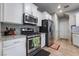 Well-lit kitchen featuring stainless steel appliances, granite countertops, and white cabinets at 6837 Dragonfly Rock St, Las Vegas, NV 89148