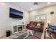 Comfortable living room features a modern entertainment center and cozy leather seating at 6837 Dragonfly Rock St, Las Vegas, NV 89148