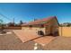 Spacious backyard featuring a tiled patio, gravel landscaping, and privacy fencing at 688 Arrowhead Canyon Dr, Henderson, NV 89002