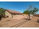 Exterior view of home showcasing a tiled patio, manicured landscaping, and a detached storage shed at 688 Arrowhead Canyon Dr, Henderson, NV 89002