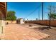 Large backyard featuring a paved patio area, shed, and a built-in fire pit at 688 Arrowhead Canyon Dr, Henderson, NV 89002