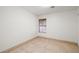 Empty bedroom with tile flooring, baseboards, and large window at 688 Arrowhead Canyon Dr, Henderson, NV 89002