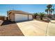 Exterior home view showcasing the spacious driveway and desert landscaping at 688 Arrowhead Canyon Dr, Henderson, NV 89002