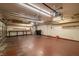 Spacious garage with overhead lighting, storage shelving, and painted concrete flooring at 688 Arrowhead Canyon Dr, Henderson, NV 89002