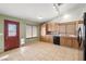 Eat in kitchen with oak cabinets and black appliances next to the entry door at 688 Arrowhead Canyon Dr, Henderson, NV 89002