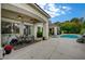 Open backyard features a covered patio, outdoor dining area, and swimming pool with waterfall feature at 729 Sir James Bridge Way, Las Vegas, NV 89145