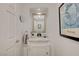 Powder room with white vanity, marble countertop, and decorative mirror at 729 Sir James Bridge Way, Las Vegas, NV 89145