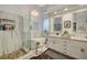 Elegant bathroom featuring marble, glass shower, standalone tub, and a beautiful chandelier at 729 Sir James Bridge Way, Las Vegas, NV 89145