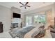 Spacious bedroom with ceiling fan, king bed, fireplace and sliding glass door leading to back patio and backyard at 729 Sir James Bridge Way, Las Vegas, NV 89145