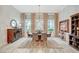Elegant dining room featuring a large round table, sophisticated chandelier, and plenty of natural light at 729 Sir James Bridge Way, Las Vegas, NV 89145