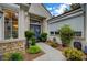 Inviting entrance with a blue double door, stone accents, lush landscaping, and bright natural light at 729 Sir James Bridge Way, Las Vegas, NV 89145