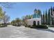Gated community entrance with manicured landscaping and a guard house at 729 Sir James Bridge Way, Las Vegas, NV 89145