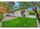 Exterior shot of the home's backyard with a covered patio and well-maintained lawn at 729 Sir James Bridge Way, Las Vegas, NV 89145