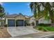 Charming single-story home with a stone accent wall and a spacious driveway leading to a three-car garage at 729 Sir James Bridge Way, Las Vegas, NV 89145