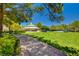 Picturesque park scene showcasing a gazebo surrounded by lush greenery, trees, and a paved pathway under a clear blue sky at 729 Sir James Bridge Way, Las Vegas, NV 89145