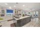Open kitchen with a large island featuring seating, flowing into a living area with access to an outdoor patio at 729 Sir James Bridge Way, Las Vegas, NV 89145