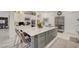 Kitchen island with marble countertop, seating, and stainless steel appliances at 729 Sir James Bridge Way, Las Vegas, NV 89145