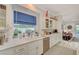 Bright kitchen with white cabinets, marble countertops, and a blue window treatment at 729 Sir James Bridge Way, Las Vegas, NV 89145