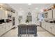 Kitchen features white cabinets, stainless steel appliances, and a large island with seating at 729 Sir James Bridge Way, Las Vegas, NV 89145