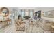 Open-concept living room showcasing stylish decor, hardwood floors, and a dining area with ample natural light at 729 Sir James Bridge Way, Las Vegas, NV 89145