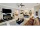 Open living room with fireplace, flowing into a gourmet kitchen with stainless steel appliances and a large center island at 729 Sir James Bridge Way, Las Vegas, NV 89145