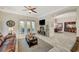 Comfortable living room with a fireplace, connecting seamlessly to the dining area and providing access to outdoor spaces at 729 Sir James Bridge Way, Las Vegas, NV 89145