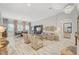Spacious living room featuring elegant decor, wood floors, a decorative chandelier, and an open floor plan at 729 Sir James Bridge Way, Las Vegas, NV 89145