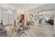 Open living space featuring wood flooring, light walls, and seamless transition to dining and kitchen areas at 729 Sir James Bridge Way, Las Vegas, NV 89145