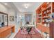 Home office with a wooden built-in bookcase and a patterned rug at 729 Sir James Bridge Way, Las Vegas, NV 89145